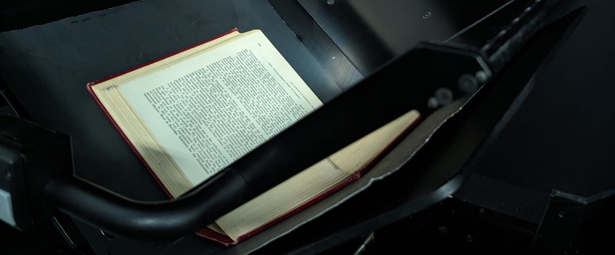 Photograph of a book in a v-scanner.
